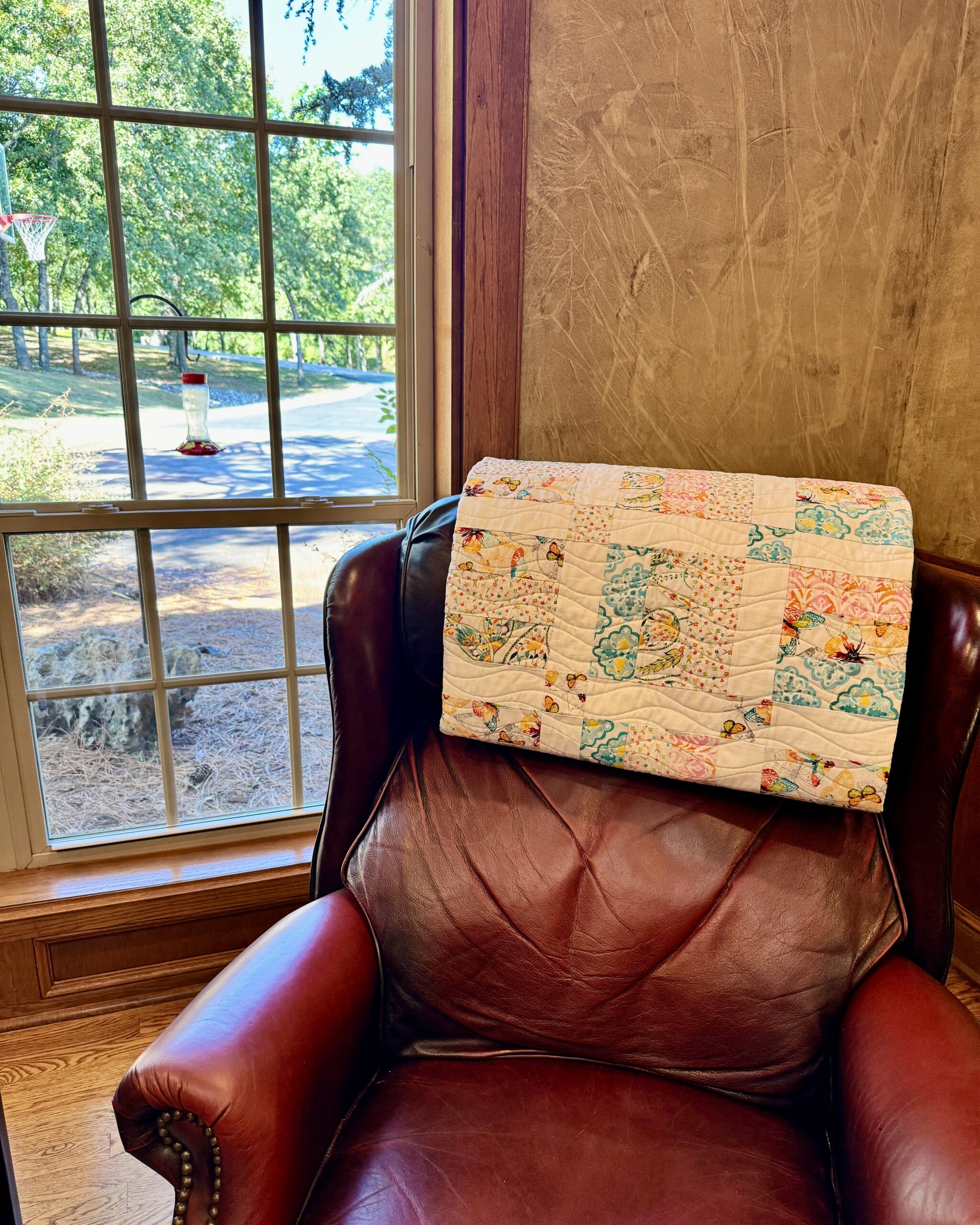 recliner with quilt draped over back