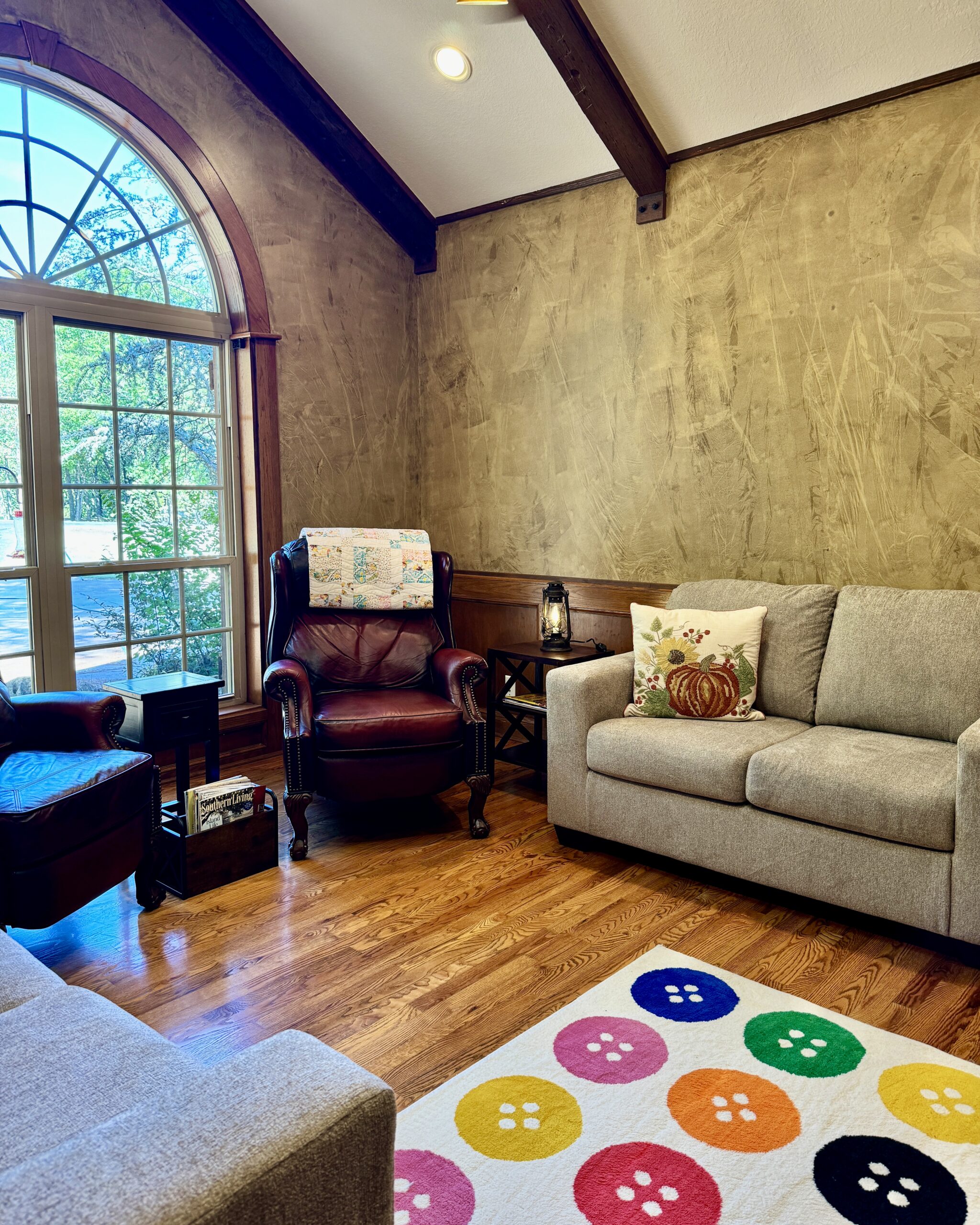 room with sofa, two recliners and picture window